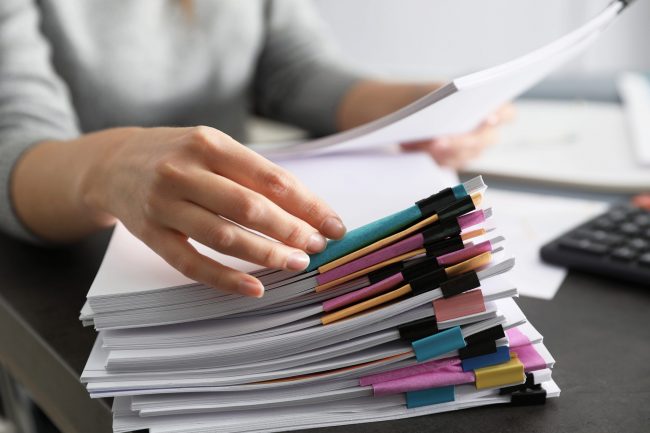 Office employee working with documents at table